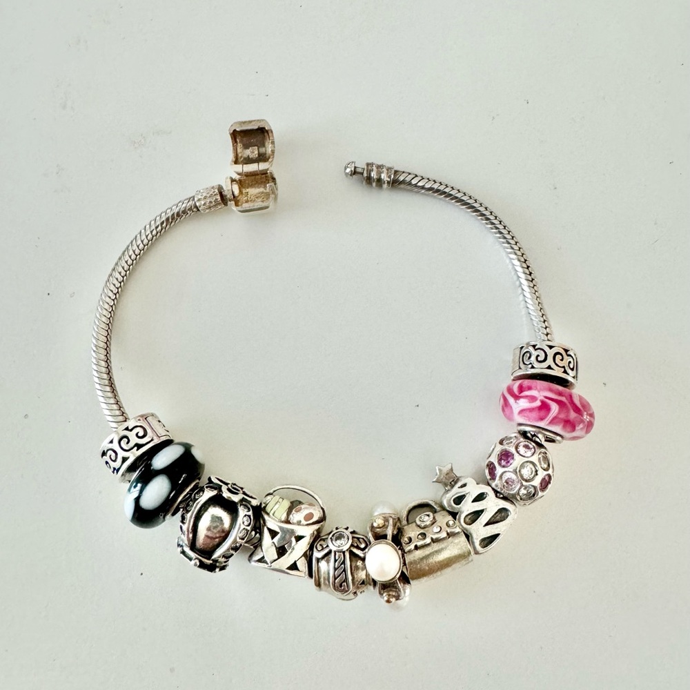 Chamilia Sterling silver charm bracelet with charms.